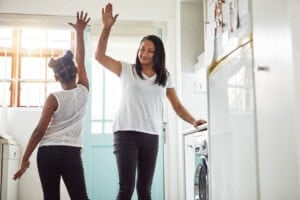 Shot of a mother and daughter high-fiving after finishing their chores