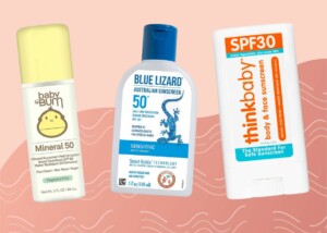 Three sunscreen products are shown against a peach-colored background with wavy lines. From left to right: Baby Bum Mineral 50 sunscreen stick, Blue Lizard Australian Sunscreen lotion SPF 50+, and Thinkbaby SPF 30 body and face sunscreen stick. Discover the best baby sunscreen options that are gentle yet effective.